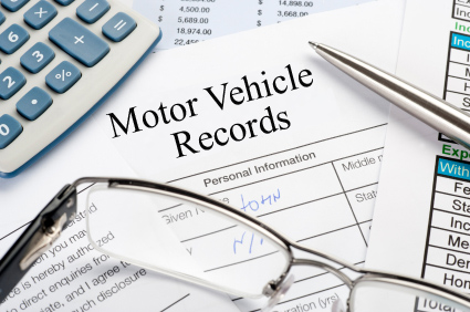 Handwritten Insurance Claim Form with pen and calculator Motor Vehicle Records